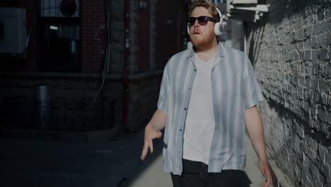 man dancing in an alley with headphones