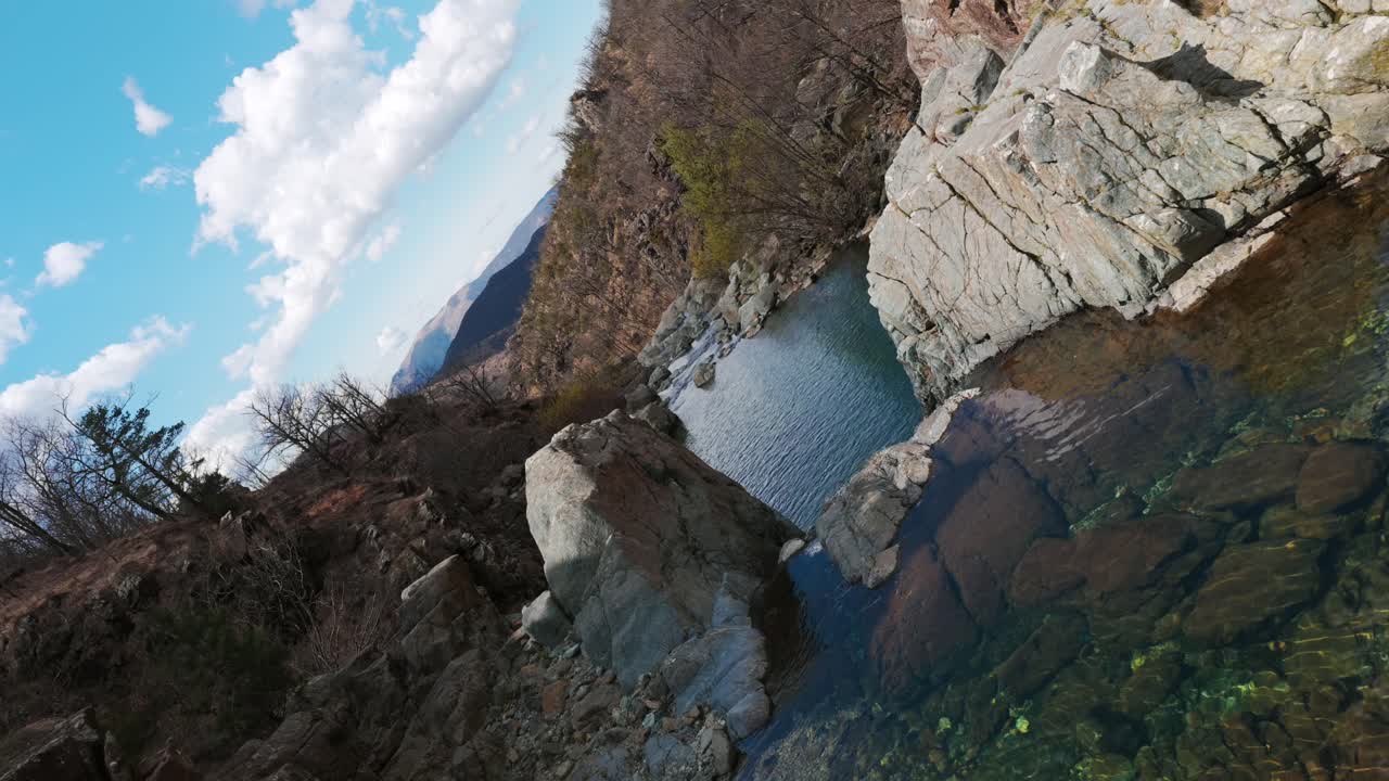 Serene Rocky Stream Through Narrow Gorge In Praglia, Liguria, Italy. rotating drone shot, pullback