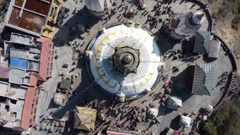 a rising straight down aerial view of swayambhunath stupa in the city of kathmandu, nepal