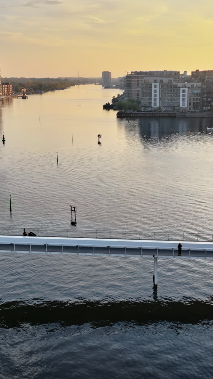 Aerial drone view of the Quay Bridge across the port of Copenhagen, Denmark at sunset. Vertical