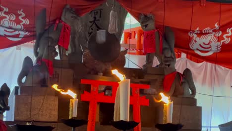 candles in a shrine at fushimi inari taisha in japan