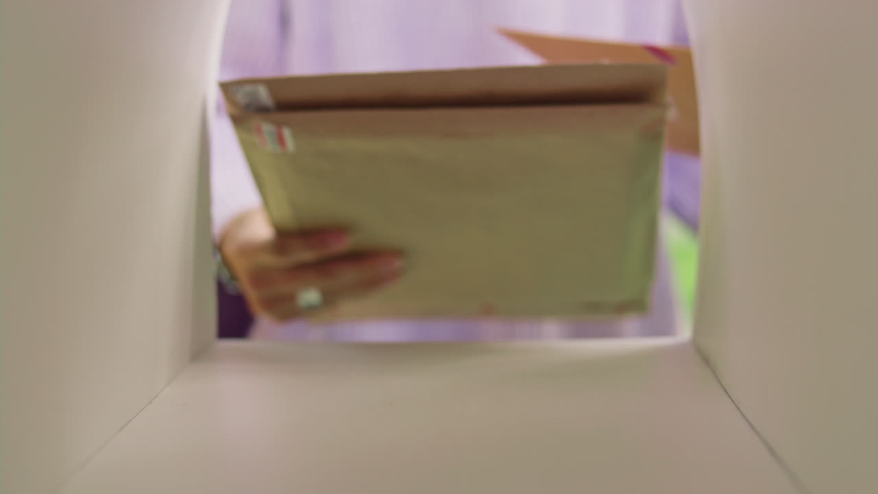 Close Up of Woman Picking Up Envelopes from Mailbox