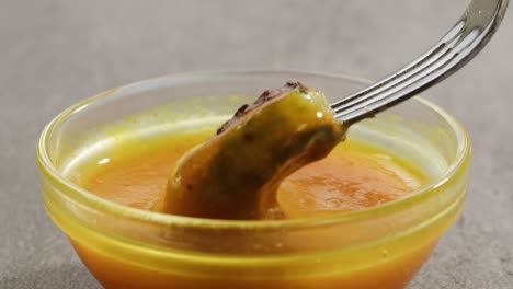 grilled vegetable in a spicy sauce with fork