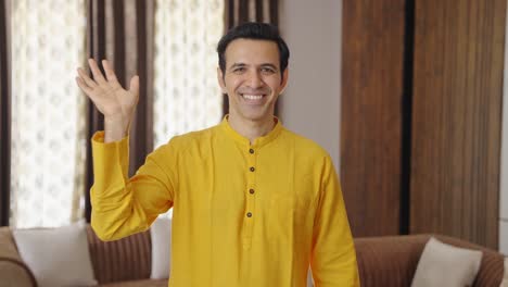 happy indian man waving hand and saying hello