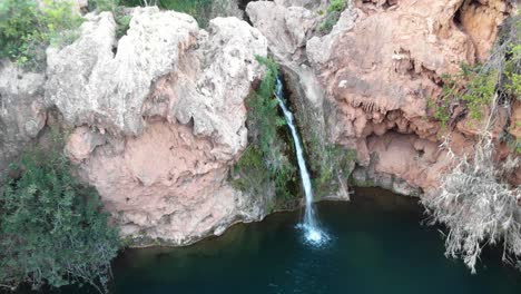 aerial view of a serene waterfall in a lush forest