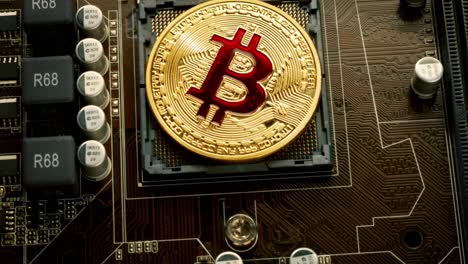 Gold-Bit-Coin-BTC-coins-on-the-motherboard.-Bitcoin-is-a-worldwide-cryptocurrency-and-digital-payment-system-called-the-first-decentralized-digital-currency.