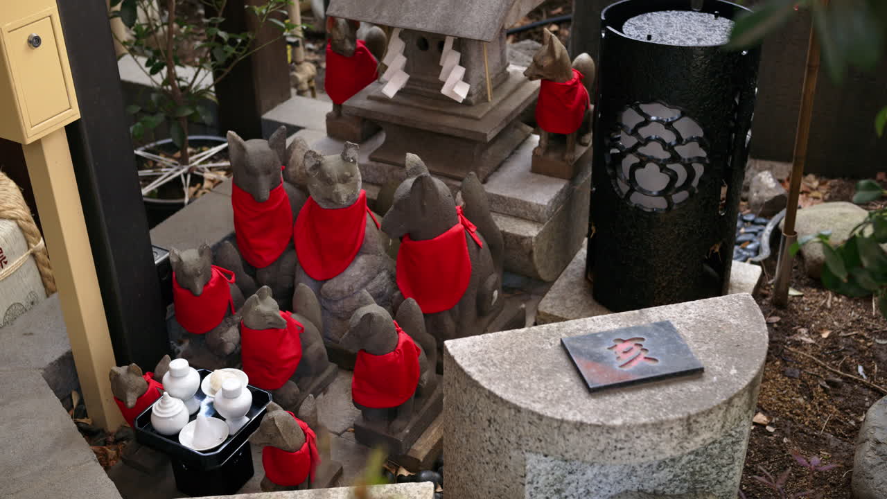 Close up of multiple Japanese fox statues in a temple