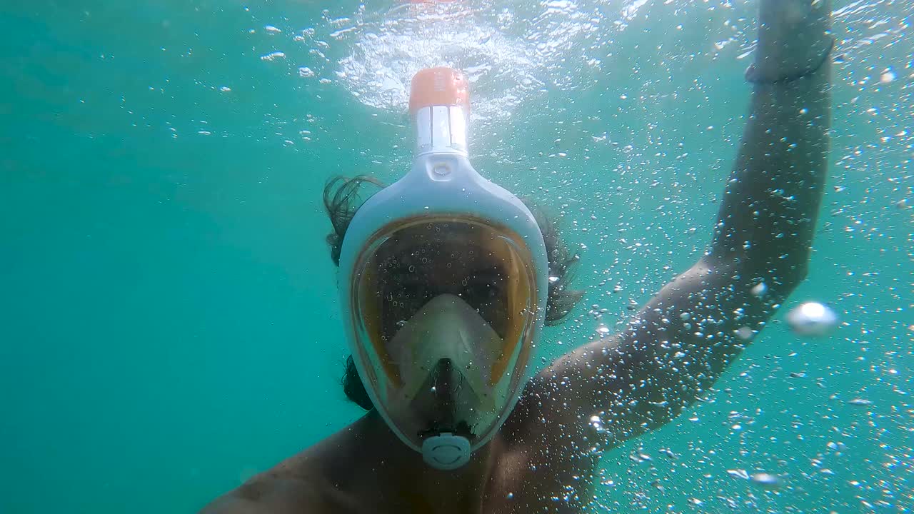 POV shot of a diver creating bubbles and reducing his visibility