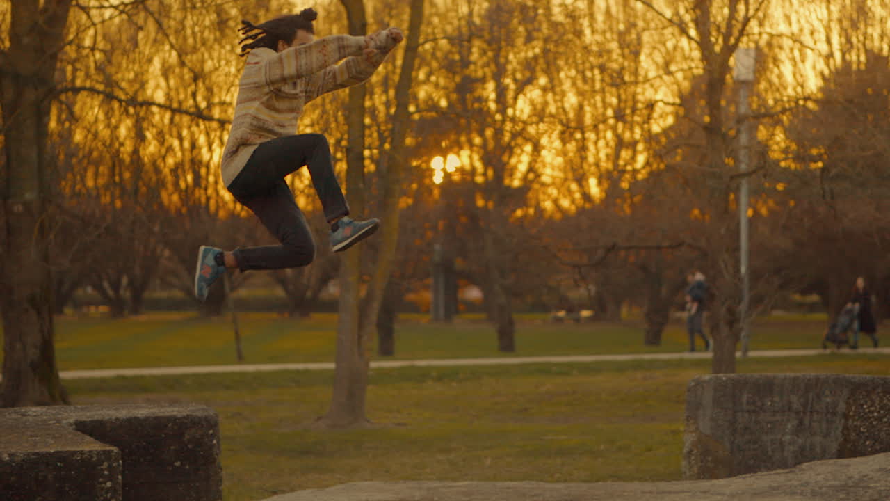 Man jumping in park at sunset
