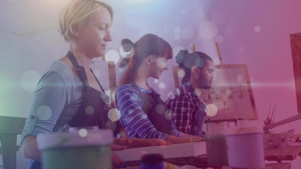 White spots of light floating against group of people women at studio