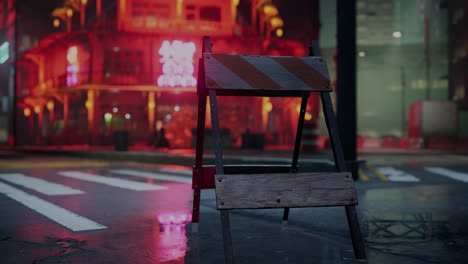 a nighttime scene of a city street with a barricade and neon lights