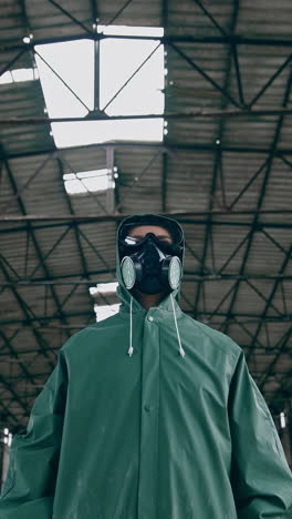 portrait of a person in gas mask in destroyed building. technogenic catastrophe. post apocalyptic world. survivor after nuclear chemical war. vertical video