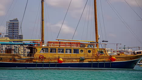 a colourful fishing boat at the harbor sailing in by the coastal city in malta