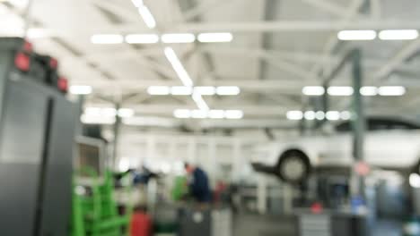 blurred view of a busy car repair shop