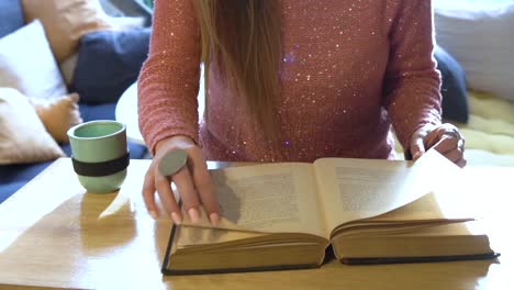 woman reading a book in a cozy setting