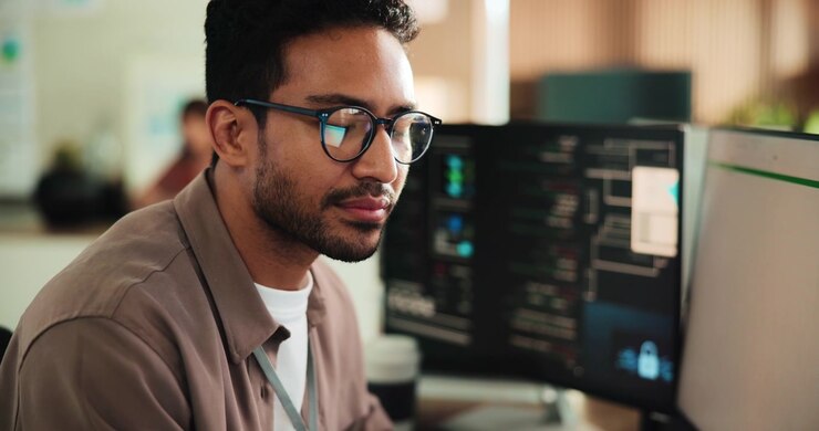 Young Software Developer Working on Code in Modern Office
