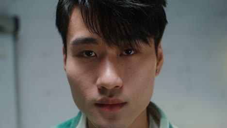 Close-up portrait of a young Asian man