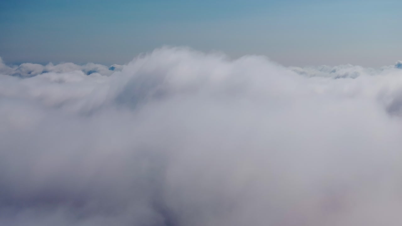 Peaceful drone descent through layered clouds in crisp atmosphere above Earth