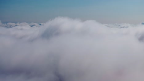 peaceful drone descent through layered clouds in crisp atmosphere above earth