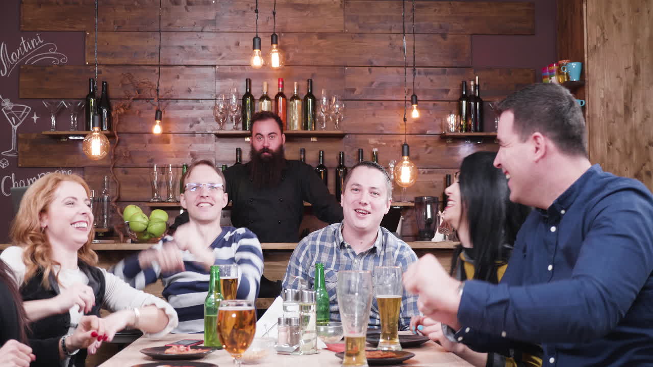 Group of friends celebrating at a bar