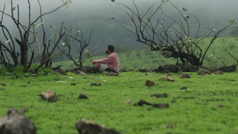 Man-sitting-by-himself-in-green-nature