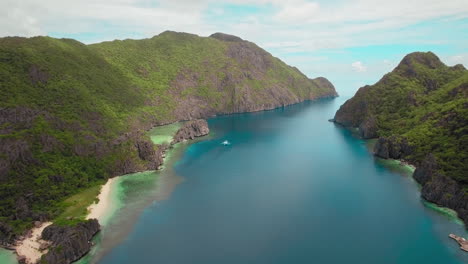 Approaching-Aerial-Shot-Of-Beautiful-Mountain-Island-And-Clear-Blue-Sea-In-Palawan-Philippines