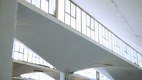 architectural interior with concrete support beams and windows