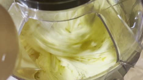 condensed milk being added to cookie batter while in the mixer