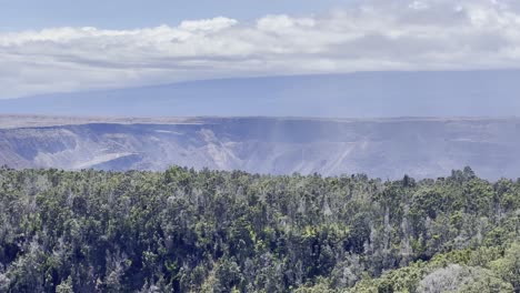 Cinematic-long-lens-panning-shot-of-the-Kilauea-Crater-from-an-overlook-on-the-Kilauea-Iki-trail-in-Hawai'i-Volcanoes-National-Park