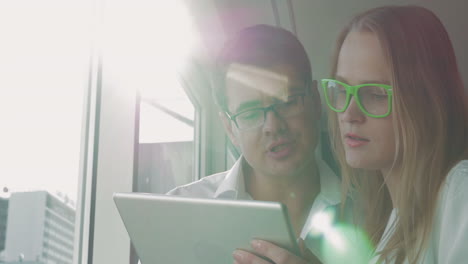 man and woman with pad talking about business