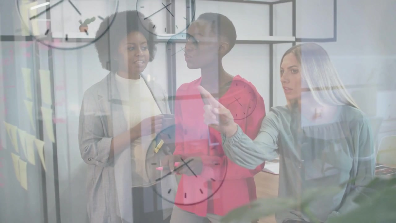 Three women aligning focus in office as right woman pointing and center using pen, clocks floating
