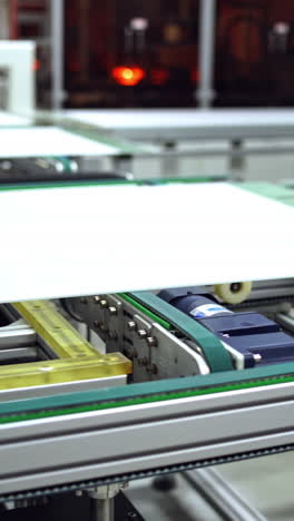 working factory mechanism of making solar panels. automated equipment for doing solar energy production. innovation technology concept. vertical video