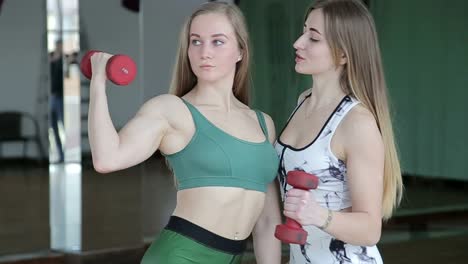 a stunning young woman engages in a dumbbell workout within a night-time fitness studio illuminated by vibrant neon lights, capturing the fusion of strength and modern aesthetics