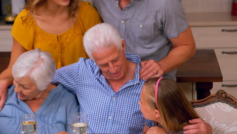 cute family standing in front of the kitchen table