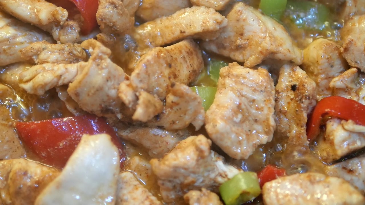 Spiced Chicken and Bell Peppers Simmering in a Pan