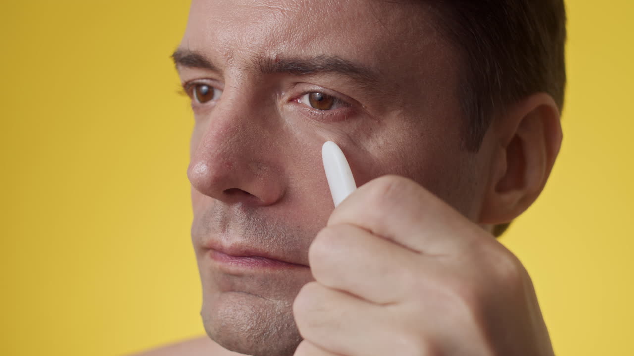 Caucasian Mid-adult Practicing Facial Massage with Gua Sha