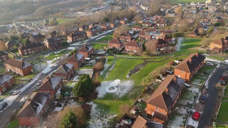 drone's-eye winter view captures dewsbury moore council estate's typical uk urban council-owned housing development with red-brick terraced homes and the industrial yorkshire