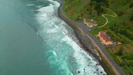 Carretera-Costera,-Olas-Del-Océano-Y-Asentamientos-En-La-Isla-De-Madeira,-Portugal---Toma-Aérea