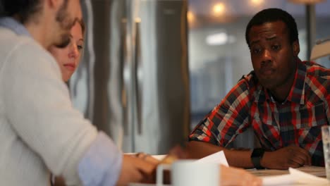 Business-colleagues-discussing-over-document-in-conference-room-4k