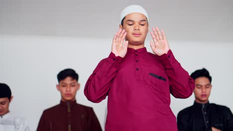 group of muslim doing ruku prayer movements on prayer mat