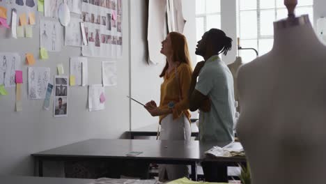 Caucasian-woman-and-mixed-race-man-working-in-fashion-office