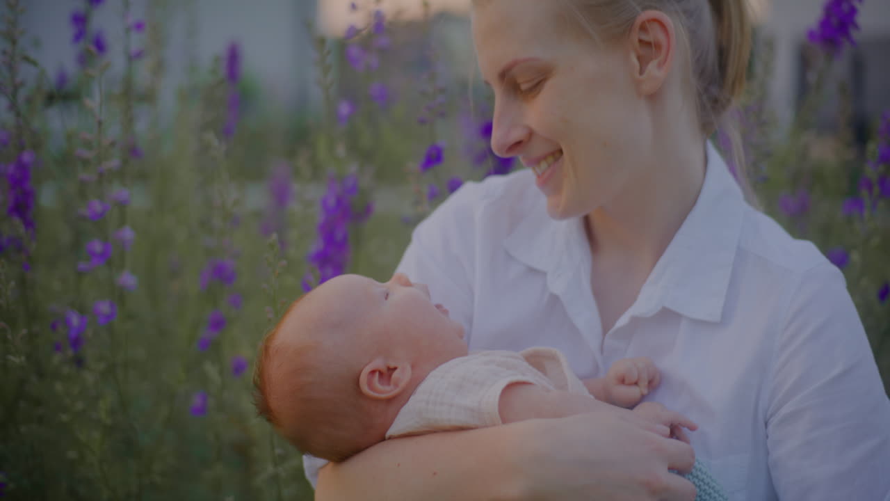 Mother Hugging Baby with Blossoming Flowers