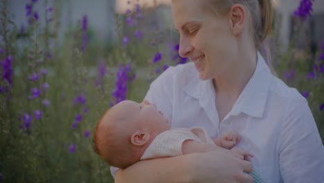 mother hugging baby with blossoming flowers