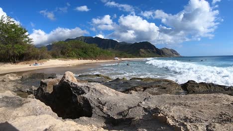 time lapse of a typical day at the beach west side oahu with rocks swimmers volcanic crater white sand and vegetation