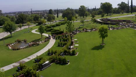 Low-aerial-shot-flying-over-decorated-private-estates-burial-grounds-at-a-California-mortuary