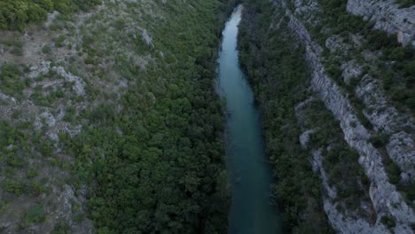 Full-length-descriptive-panning-drone-video-moving-over-the-canyon-of-Lake-Zrmanja-in-Croatia