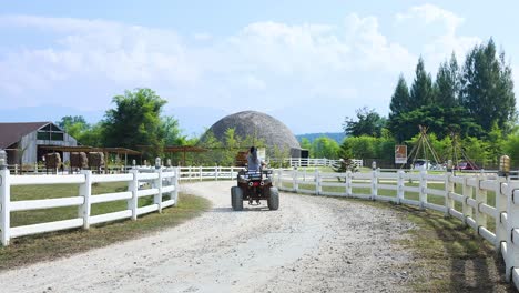 person riding an atv along a gravel path