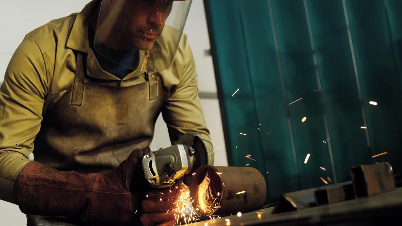 Welder working at work shop
