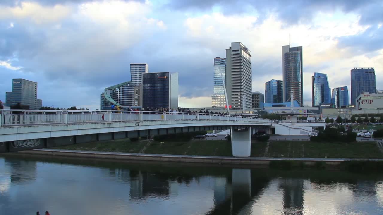 White Bridge With Skyline And Skyscrapers in the Capital City Vilnius, Lithuania, Baltic States, Europe. Time Lapse