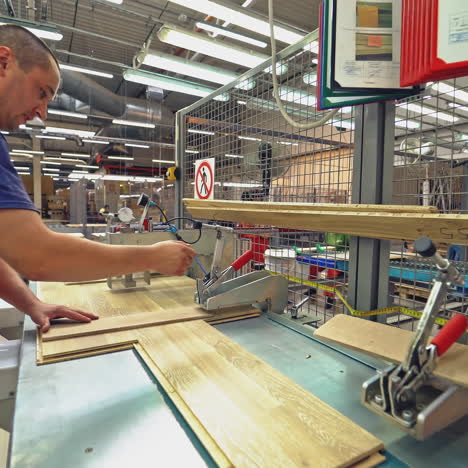 carpenter working with industrial tool in wood factory.